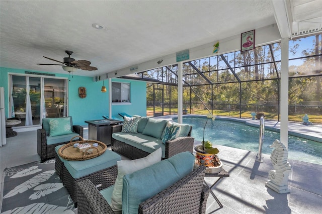 view of patio with glass enclosure, an outdoor living space, and ceiling fan