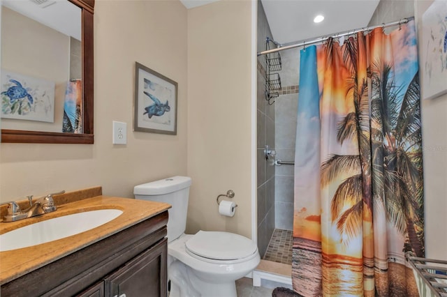 bathroom with tile patterned floors, vanity, toilet, and curtained shower