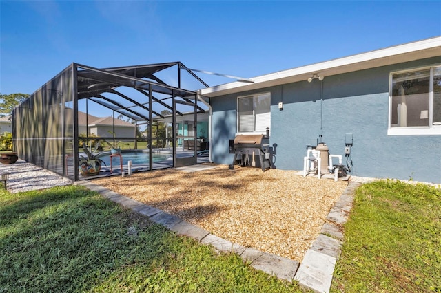 back of house with a lanai and a yard