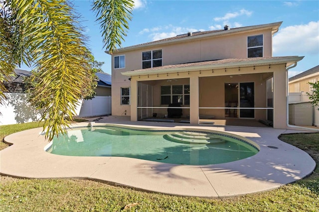 rear view of property with a patio area and a sunroom