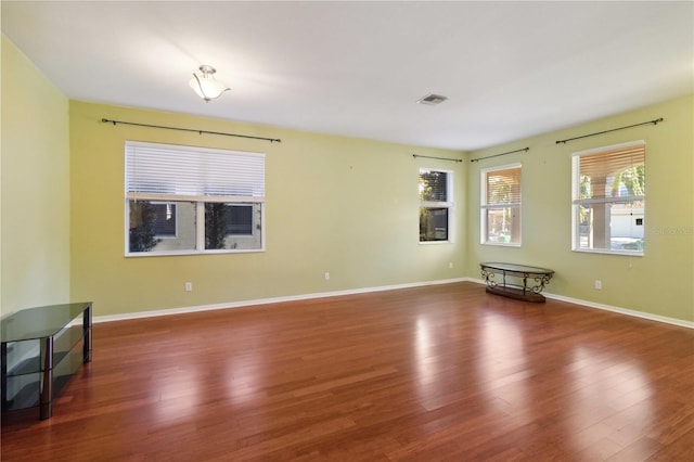 spare room with dark hardwood / wood-style flooring