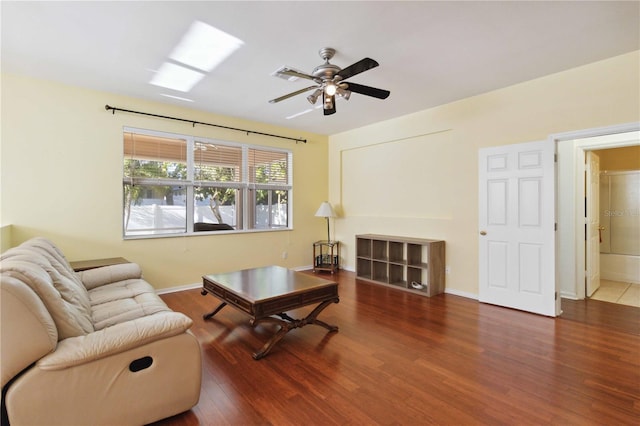 living room featuring ceiling fan and dark wood-type flooring