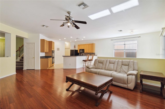 living room with hardwood / wood-style flooring and ceiling fan