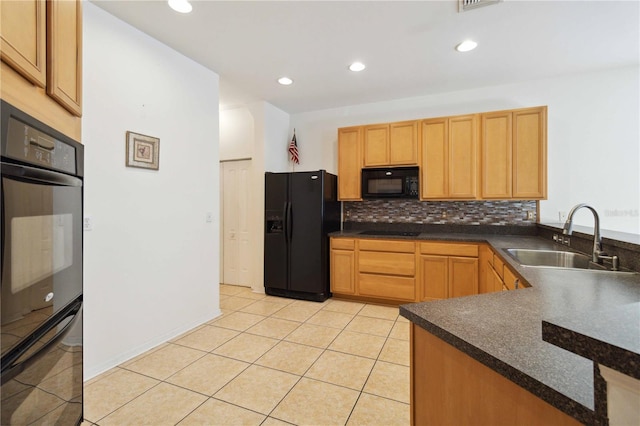 kitchen featuring tasteful backsplash, sink, light tile patterned flooring, and black appliances