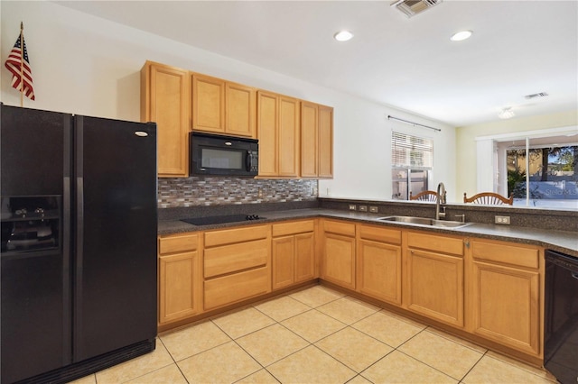 kitchen with tasteful backsplash, sink, light tile patterned flooring, and black appliances