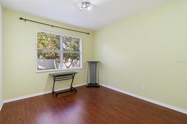 empty room featuring dark wood-type flooring