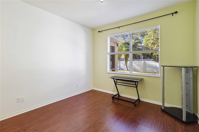 empty room featuring dark hardwood / wood-style flooring