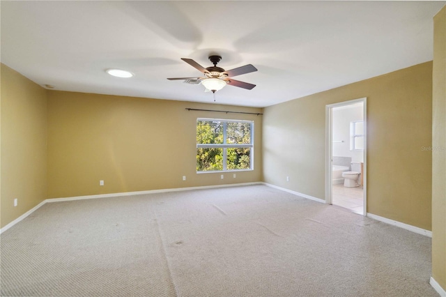 spare room with light colored carpet and ceiling fan