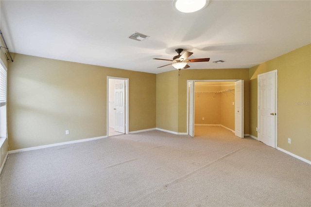 spare room with light carpet and ceiling fan