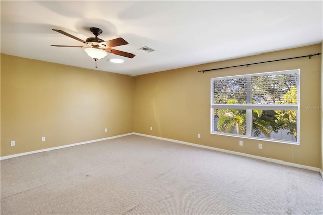 unfurnished room featuring ceiling fan and carpet floors