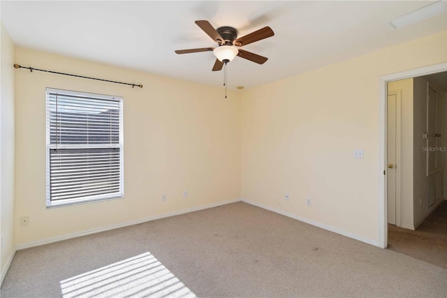 carpeted empty room featuring ceiling fan