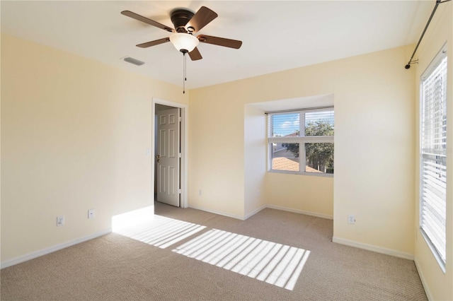 unfurnished bedroom featuring light carpet and ceiling fan