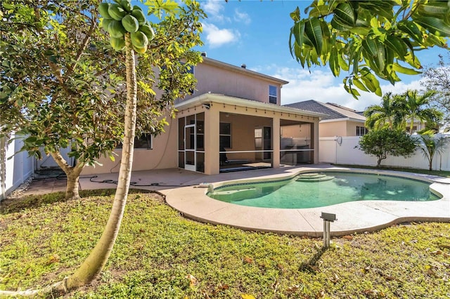 view of swimming pool with a patio and a sunroom