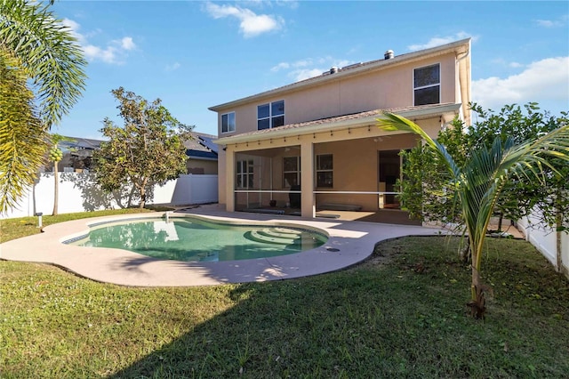 back of property featuring a yard, a fenced in pool, a patio, and a sunroom