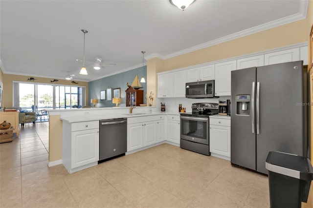 kitchen featuring white cabinetry, hanging light fixtures, stainless steel appliances, kitchen peninsula, and crown molding