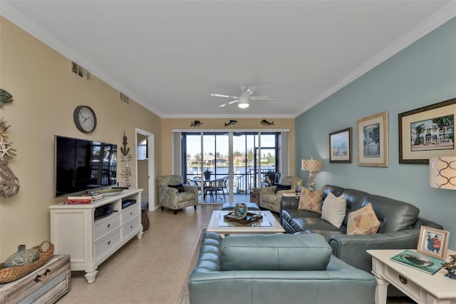 tiled living room with ceiling fan and ornamental molding