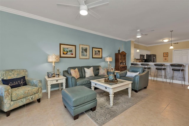 living room with crown molding, light tile patterned flooring, and ceiling fan