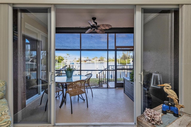 dining area with ceiling fan and a wall of windows