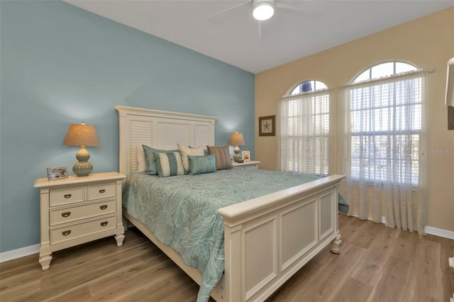 bedroom with ceiling fan and light wood-type flooring