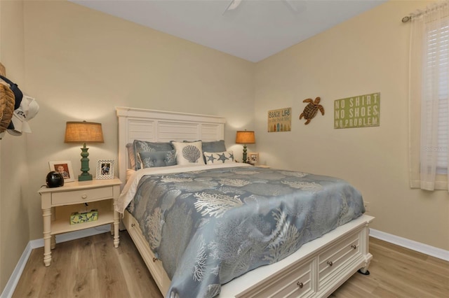 bedroom with ceiling fan and light wood-type flooring