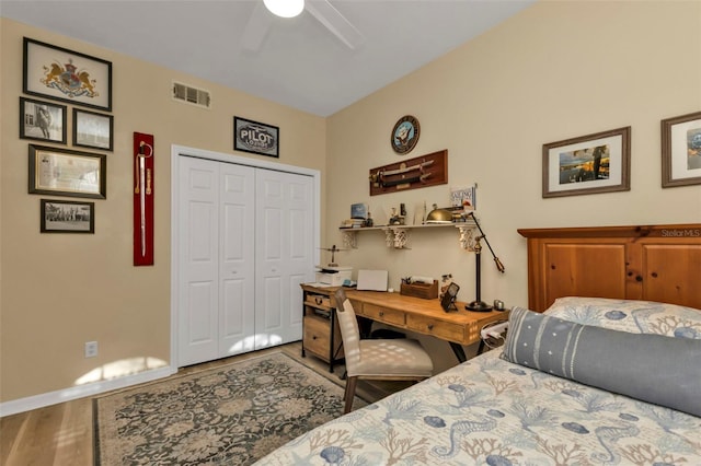 bedroom featuring wood-type flooring, a closet, and ceiling fan