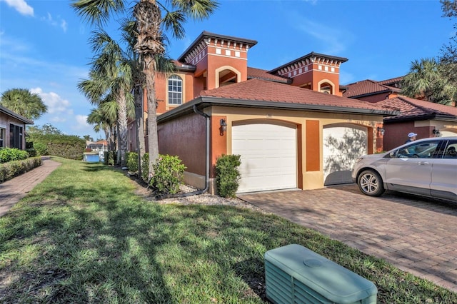 view of side of property with a yard and a garage