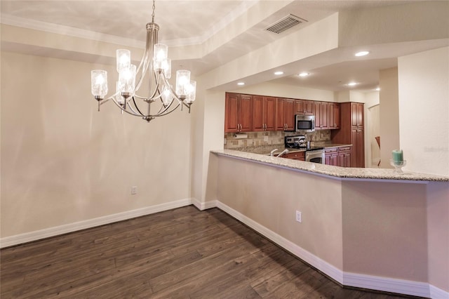 kitchen featuring light stone countertops, stainless steel appliances, dark hardwood / wood-style floors, pendant lighting, and decorative backsplash