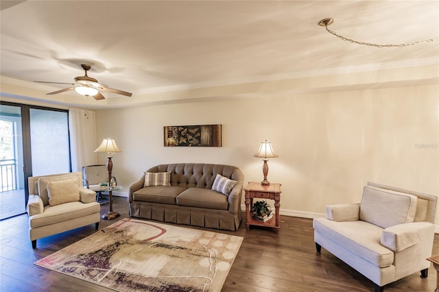 living room with ceiling fan, crown molding, and dark wood-type flooring