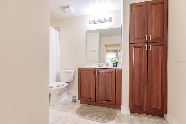 bathroom with tile patterned floors, vanity, and toilet