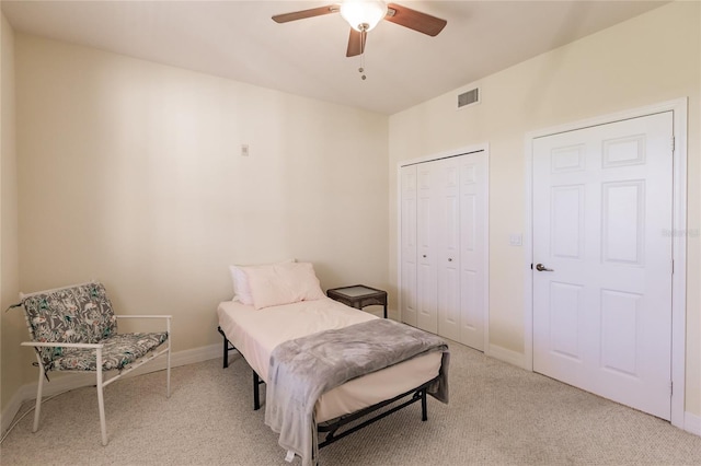 bedroom with ceiling fan and light colored carpet