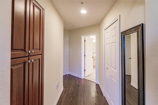 corridor with dark hardwood / wood-style floors