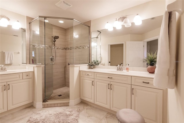 bathroom with vanity and a shower with door