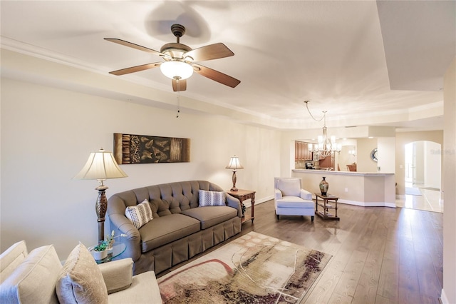 living room featuring hardwood / wood-style floors and ceiling fan with notable chandelier