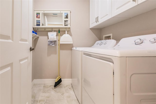 laundry area with cabinets and independent washer and dryer