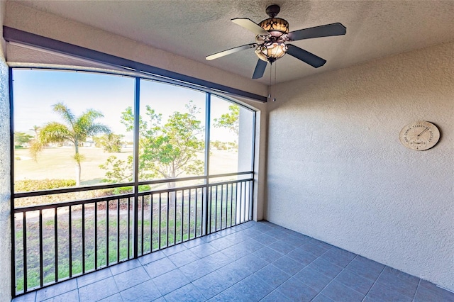 unfurnished sunroom featuring ceiling fan