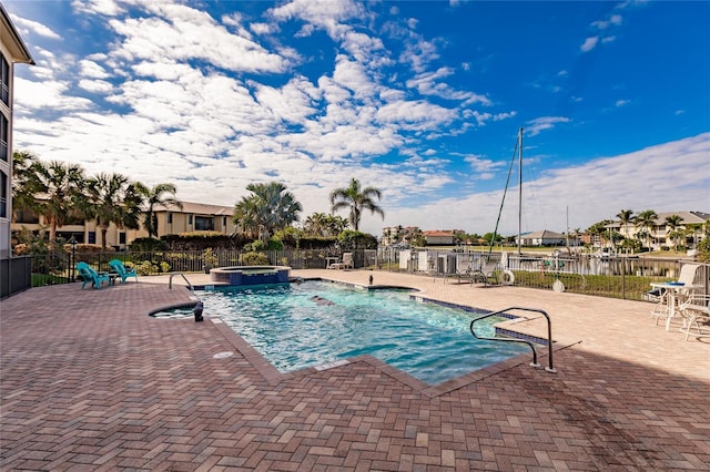 view of swimming pool with a community hot tub and a patio area