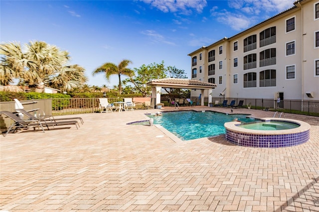 view of pool with a gazebo, a jacuzzi, and a patio