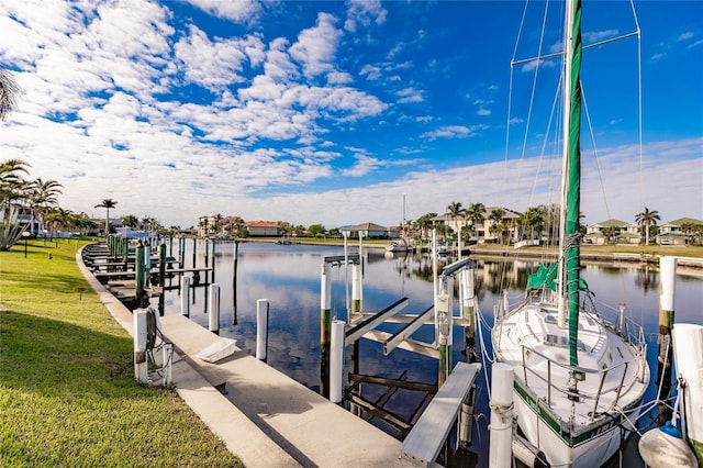 view of dock featuring a water view and a yard