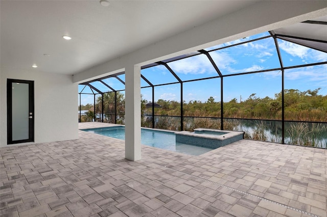 view of pool featuring a lanai, an in ground hot tub, a water view, and a patio