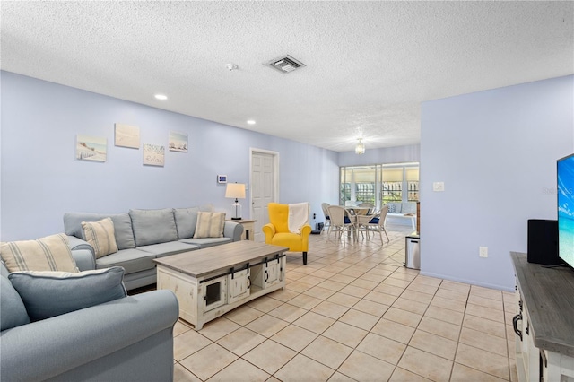 living room featuring light tile patterned floors and a textured ceiling