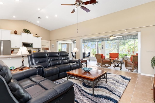 tiled living room with high vaulted ceiling, ceiling fan, and a wealth of natural light