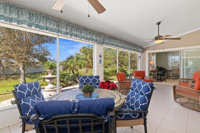 sunroom with ceiling fan and lofted ceiling