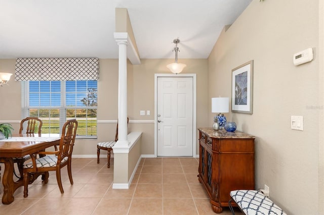 tiled foyer with vaulted ceiling and ornate columns