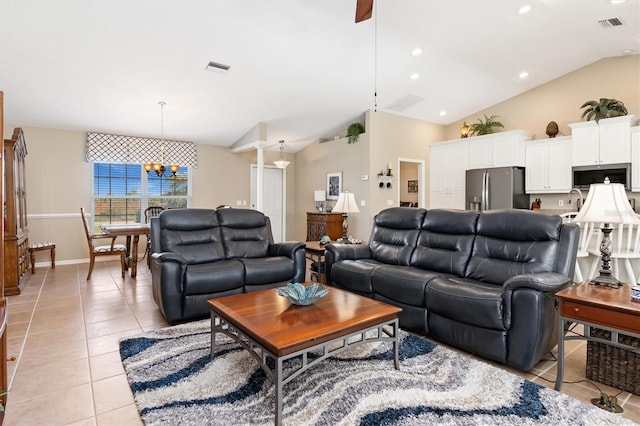 living room featuring light tile patterned floors, ceiling fan with notable chandelier, and vaulted ceiling