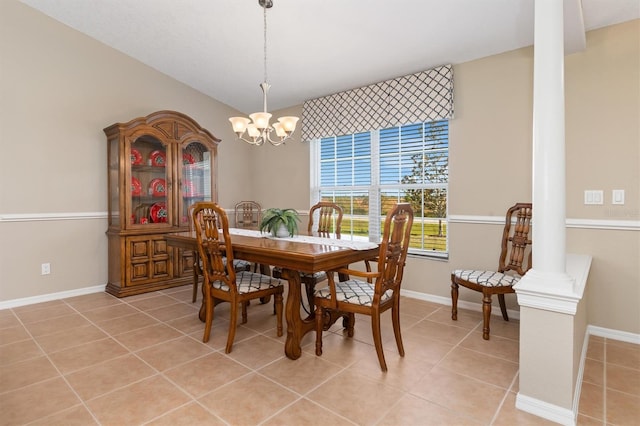 dining room featuring light tile patterned flooring, ornate columns, and a chandelier