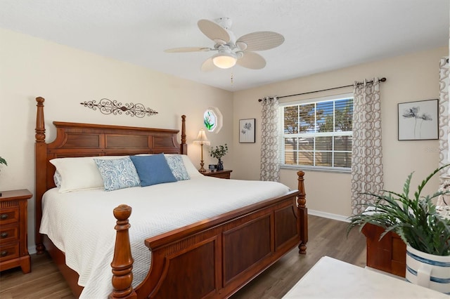 bedroom with ceiling fan and dark hardwood / wood-style floors