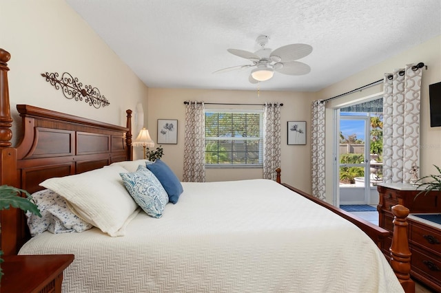 bedroom featuring a textured ceiling, multiple windows, and ceiling fan