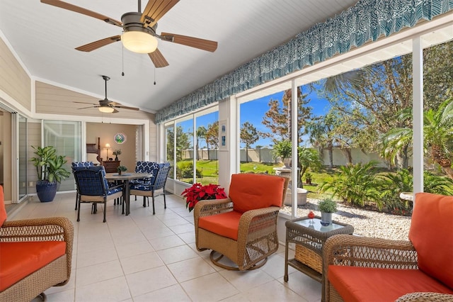 sunroom featuring vaulted ceiling and ceiling fan