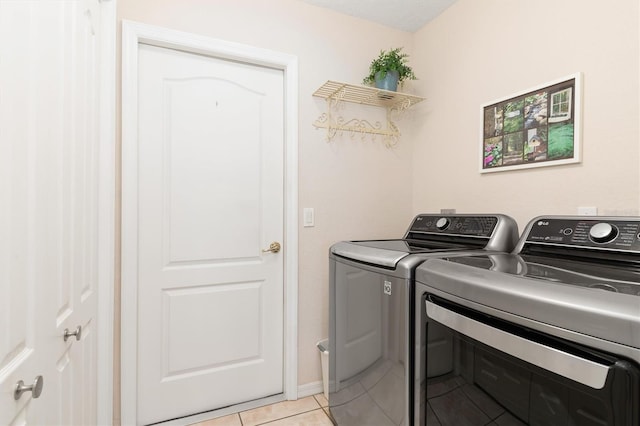 laundry room with light tile patterned flooring and independent washer and dryer