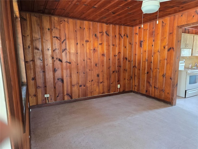 spare room featuring wood ceiling and wooden walls